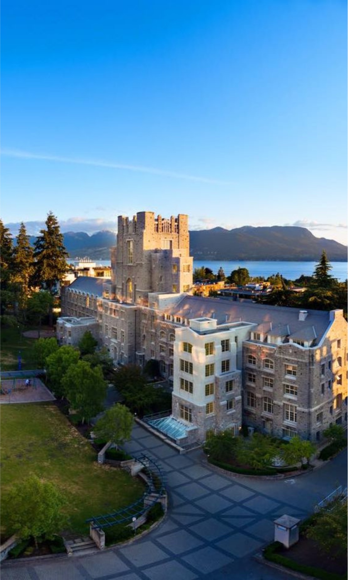 The Iona Building at UBC, with the mountains and English Bay behind it